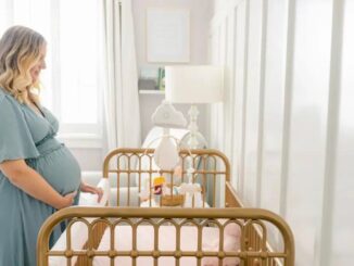 A Pregnat Woman Standing on a Baby Crib